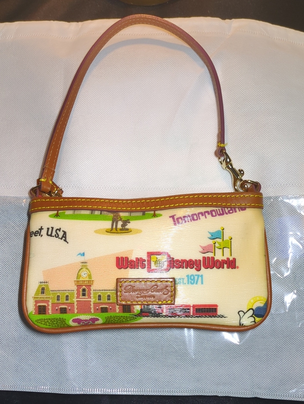 Dooney & Bourke Cream Walt Disney World Graphic Wristlet with Brown Trim $75